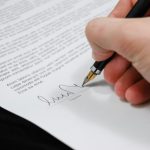 document-agreement-documents-sign-48148-48148 Close-up of a hand signing a legal document with a fountain pen, symbolizing signature and agreement.
